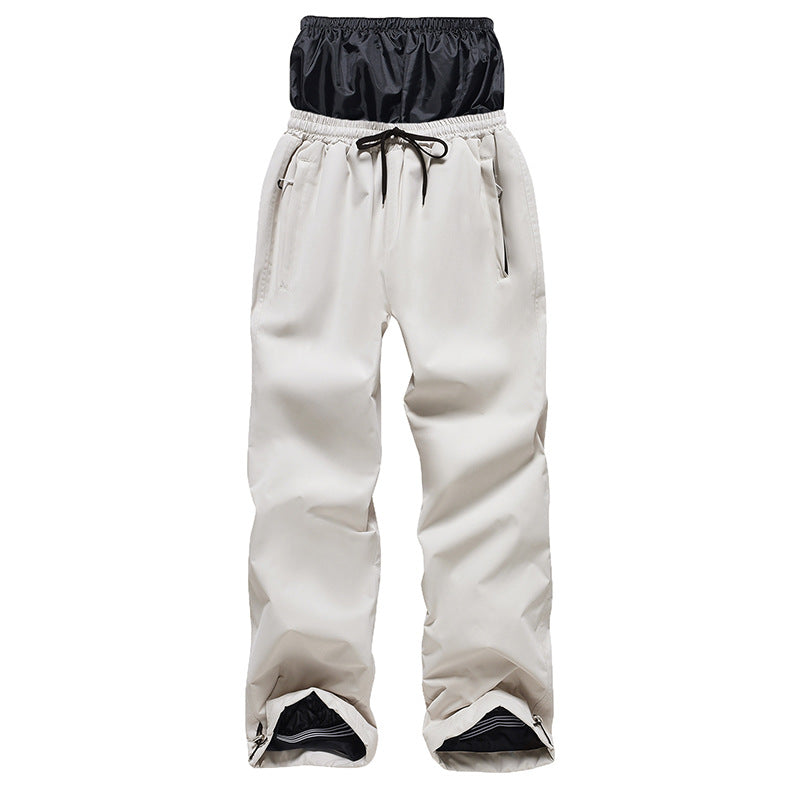 White snow pants with a black waistband on a white background