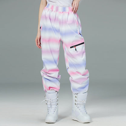 Person wearing colorful tie-dye pants with white boots on a gray background