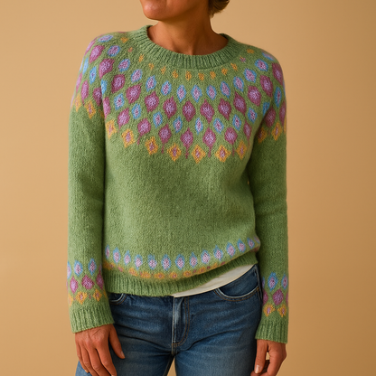 Green sweater with colorful pattern worn by a person on a beige background
