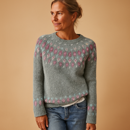 Woman wearing a gray sweater with floral patterns on a beige background