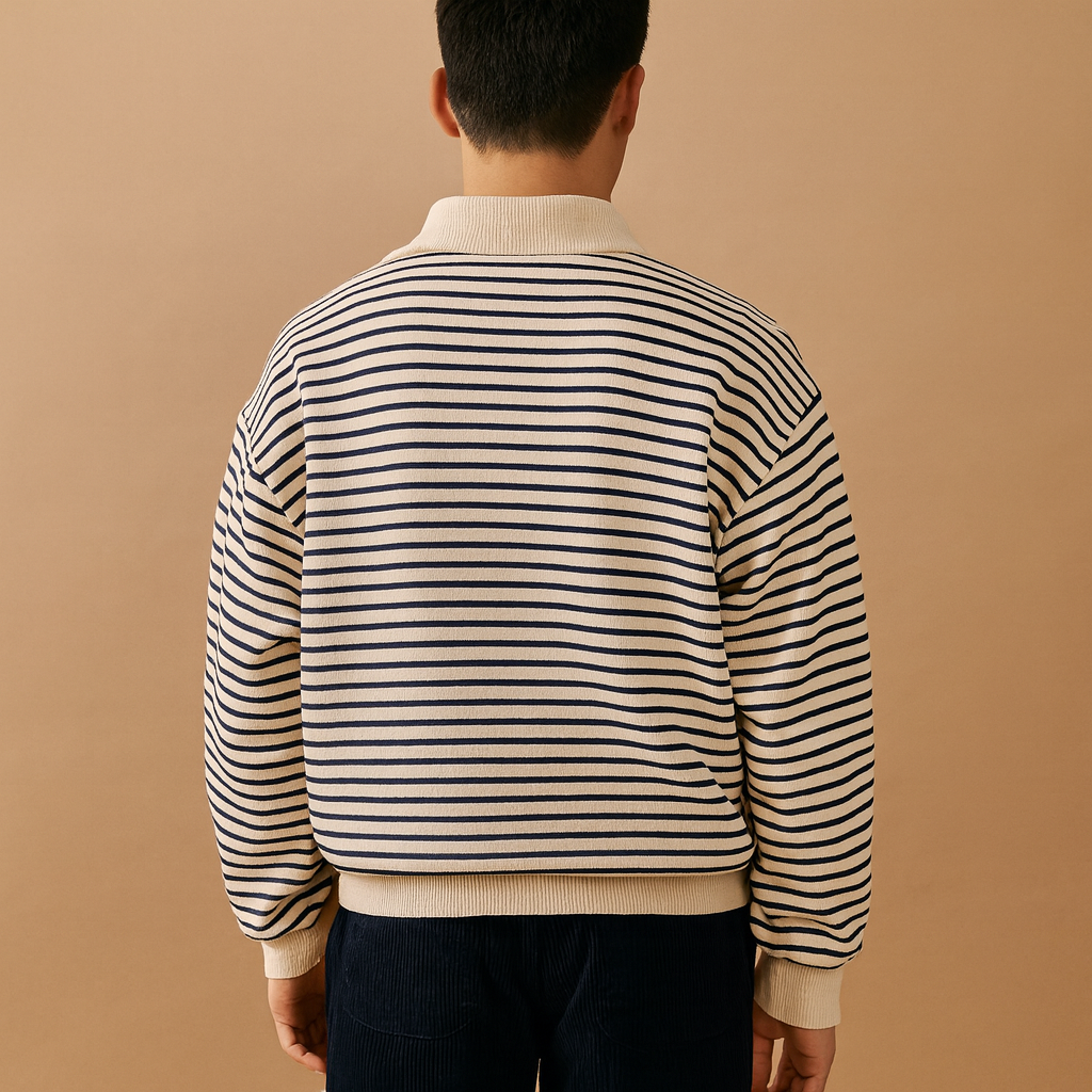 Person wearing a striped sweater against a beige background