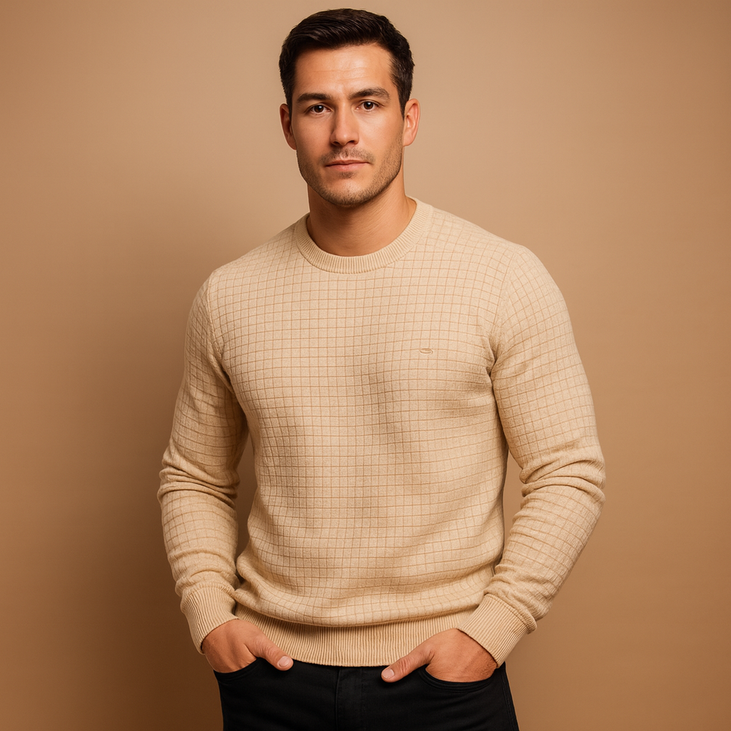 Man wearing a beige sweater against a brown background