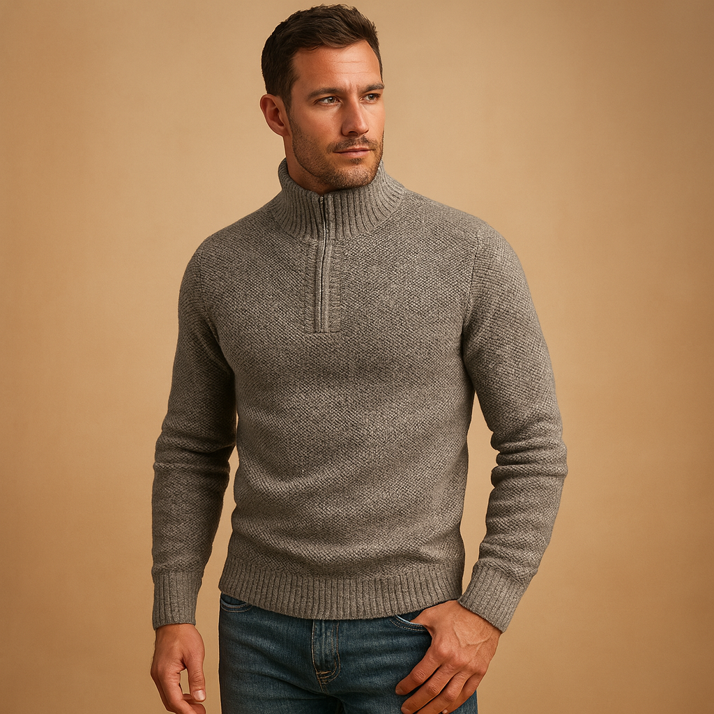 Man wearing a grey knitted sweater against a beige background