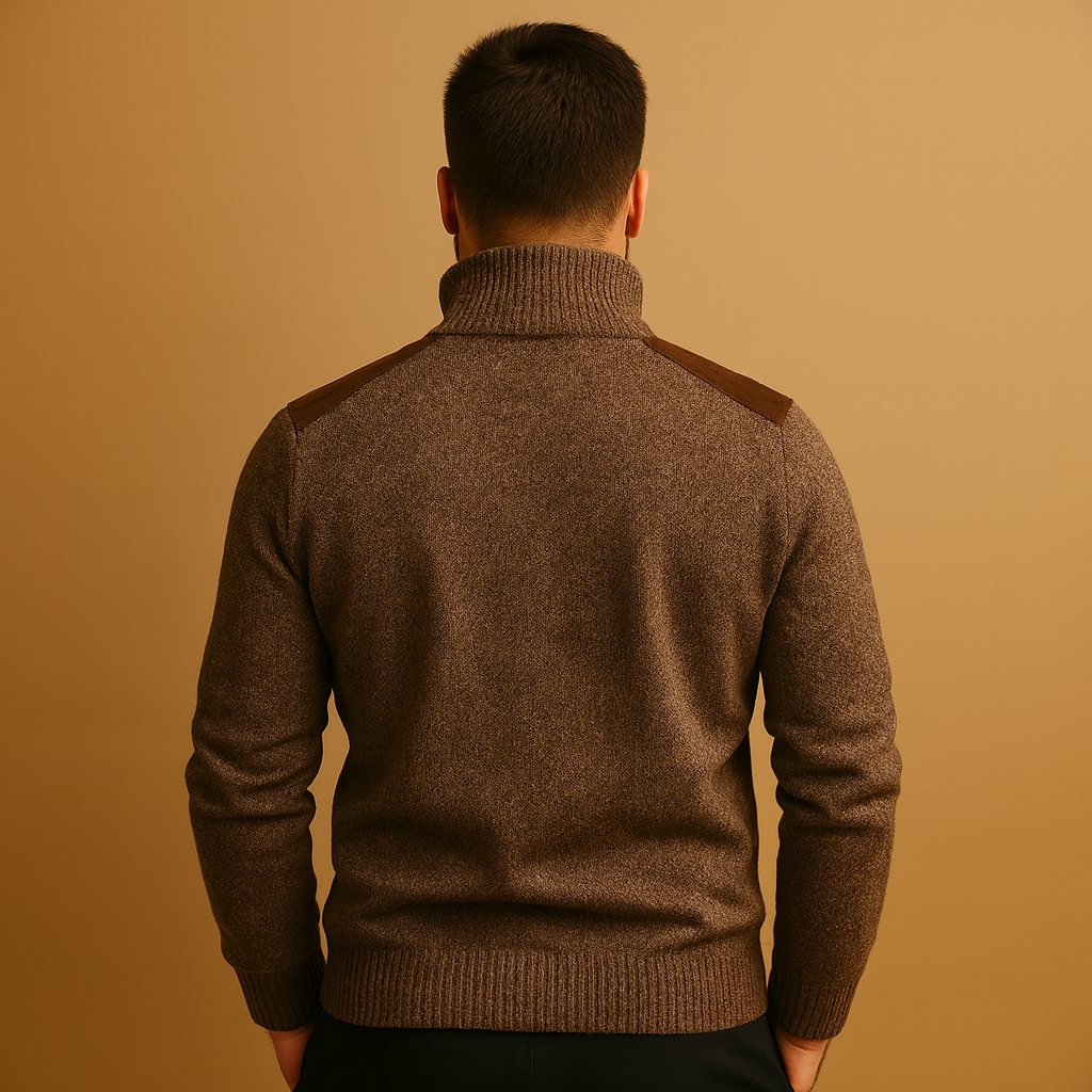 Man wearing a brown sweater with contrasting shoulder panels against a beige background
