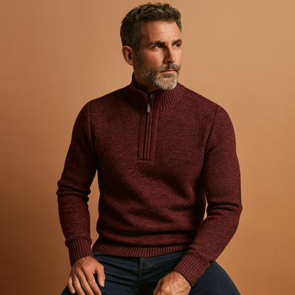 Man wearing a maroon sweater against a brown background