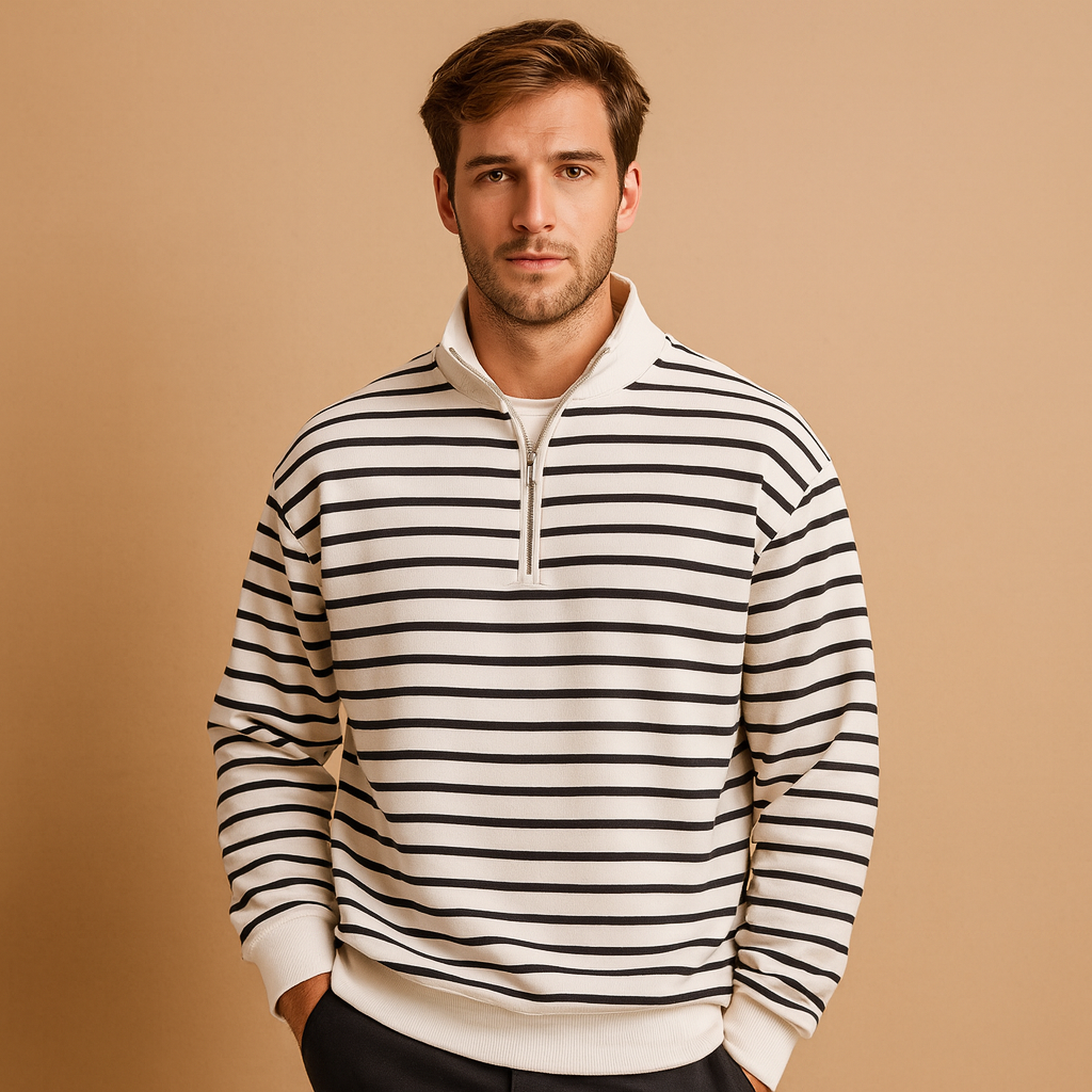 Man wearing a black and white striped sweater against a beige background