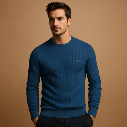 Man wearing a blue sweater against a brown background