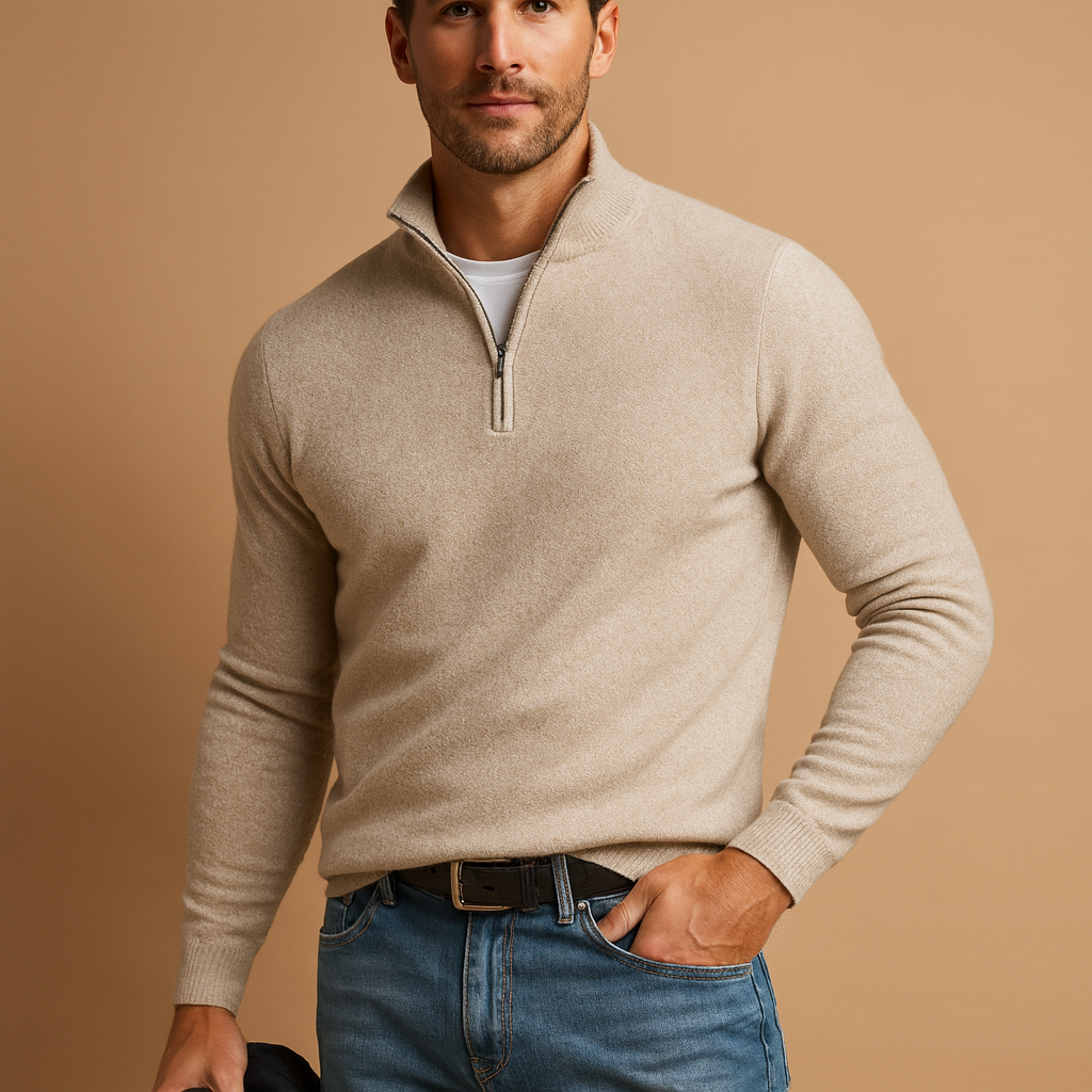 Man wearing a beige half-zip sweater and blue jeans on a brown background