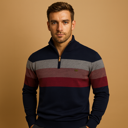 Man wearing a striped sweater with a gold zipper on a beige background